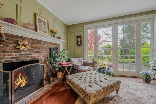 12 W Mall Dr, West Hills, NY 11743 - living area featuring a fireplace, crown molding, wood finished floors, and a decorative wall