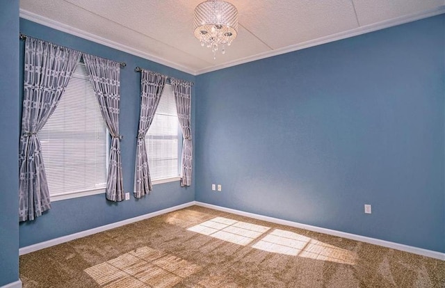 unfurnished room with crown molding, a textured ceiling, an inviting chandelier, and carpet