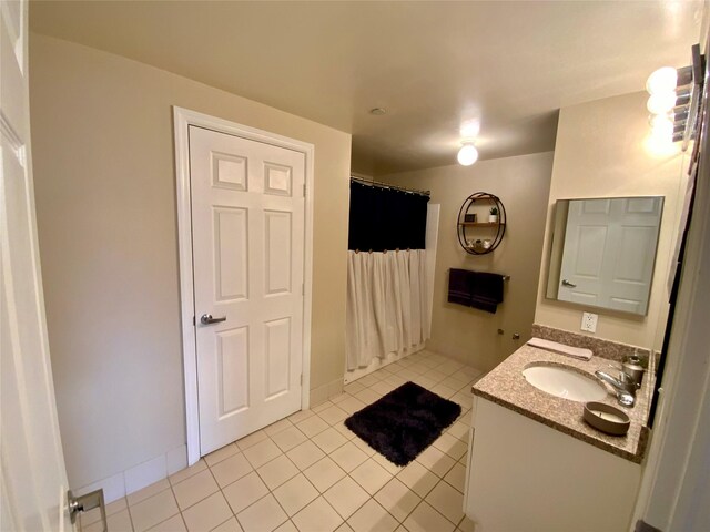 full bathroom with tile patterned floors, a shower with shower curtain, and vanity