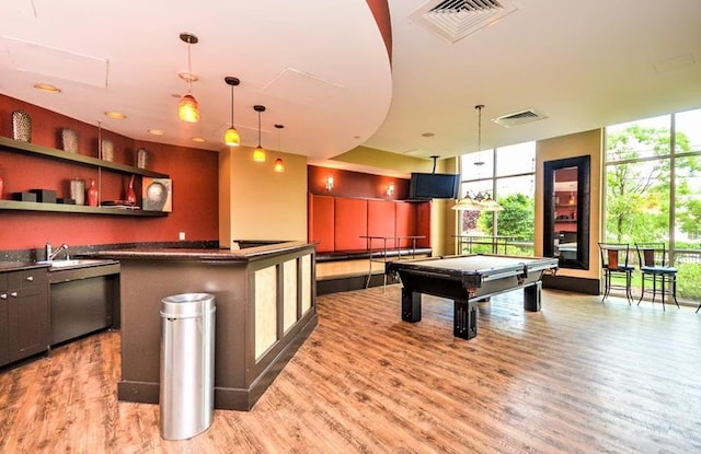 recreation room with visible vents, light wood finished floors, and plenty of natural light