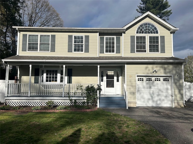 view of front of property with a porch, a front lawn, an attached garage, and aphalt driveway