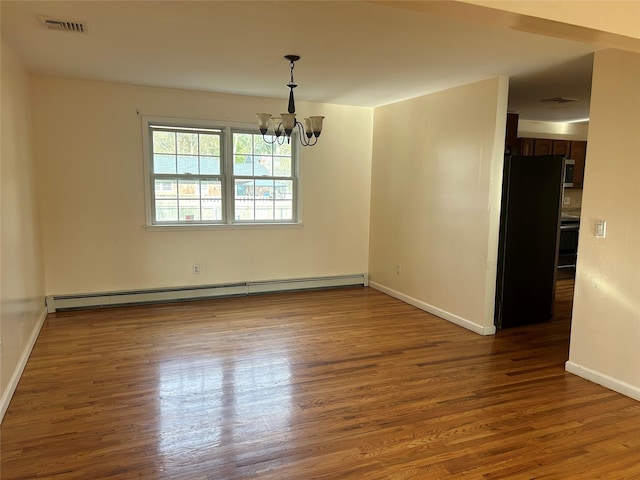 empty room featuring visible vents, baseboard heating, baseboards, wood finished floors, and a notable chandelier