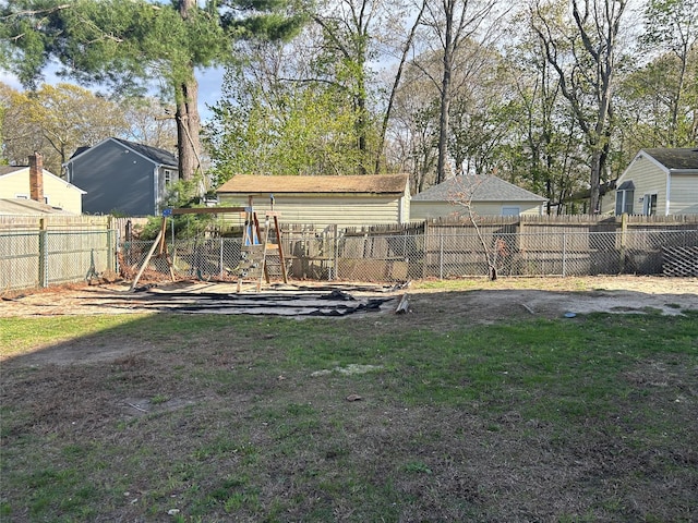 view of yard with a playground and a fenced backyard