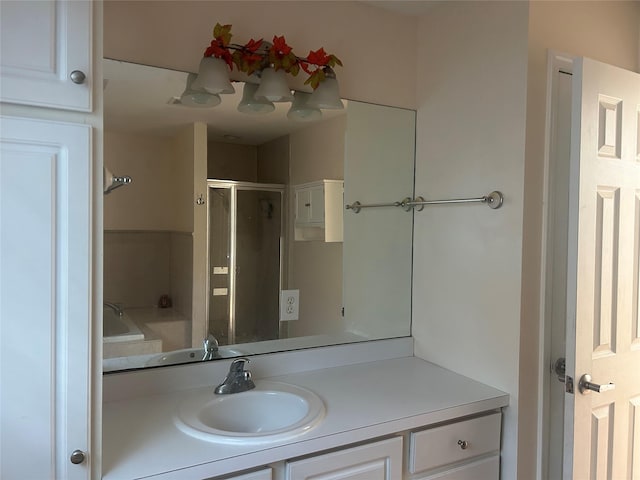 full bathroom with a shower with shower door and vanity