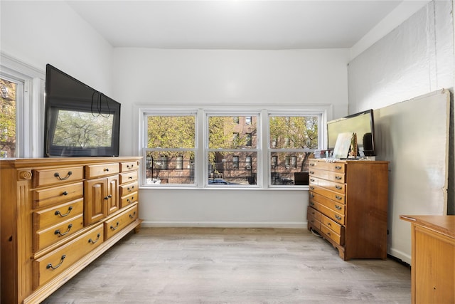 bedroom with baseboards and light wood-style floors