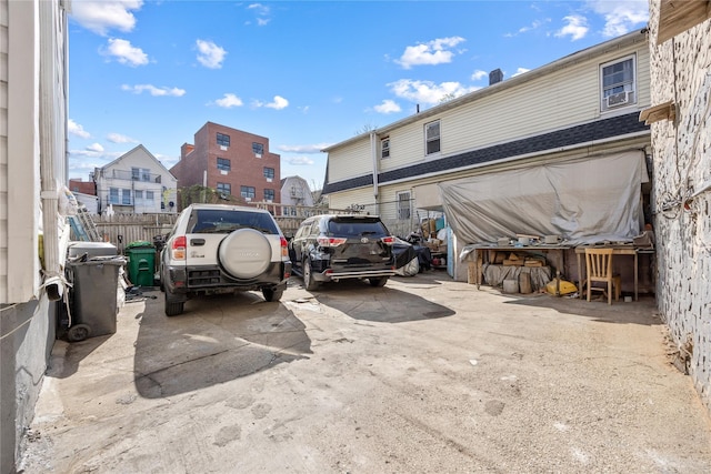 view of parking featuring fence