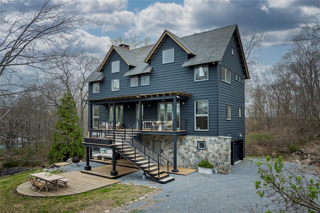 21 Private Way, Garrison, NY 10524 - victorian-style house featuring a garage, a deck, a chimney, stairs, and a shingled roof