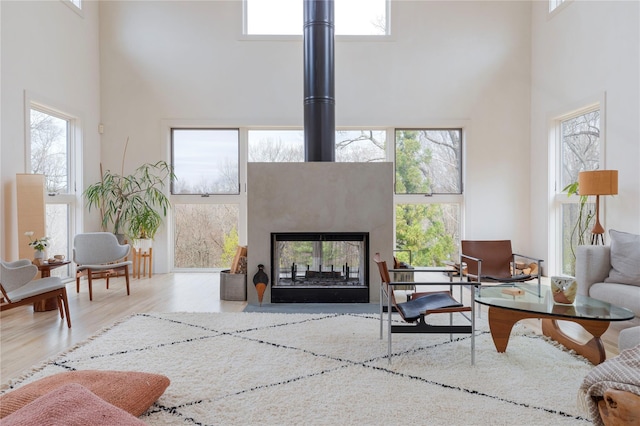 21 Private Way, Garrison, NY 10524 - living room featuring plenty of natural light, a towering ceiling, and wood finished floors