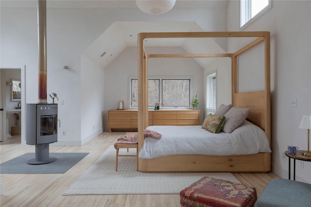 21 Private Way, Garrison, NY 10524 - bedroom featuring a wood stove, wood finished floors, and high vaulted ceiling