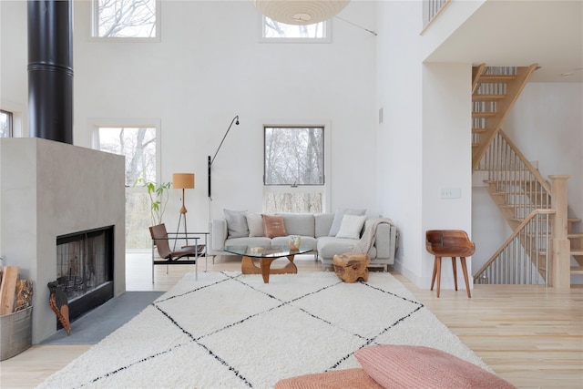 21 Private Way, Garrison, NY 10524 - living room with stairs, a high ceiling, wood finished floors, and a fireplace