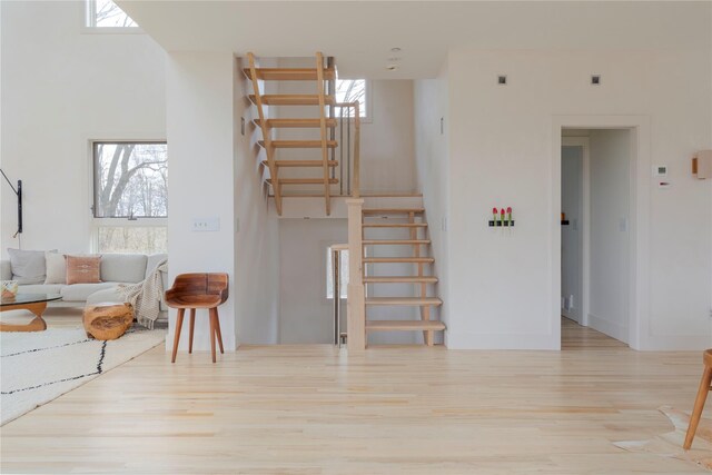 21 Private Way, Garrison, NY 10524 - living area featuring a healthy amount of sunlight, baseboards, stairs, and wood finished floors