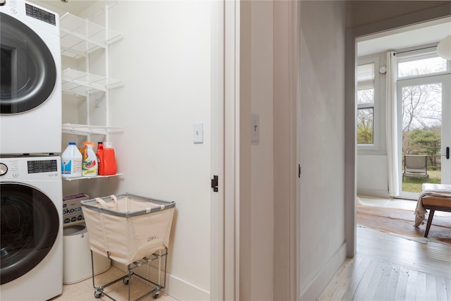 21 Private Way, Garrison, NY 10524 - laundry room featuring wood-type flooring, laundry area, baseboards, and stacked washer and clothes dryer