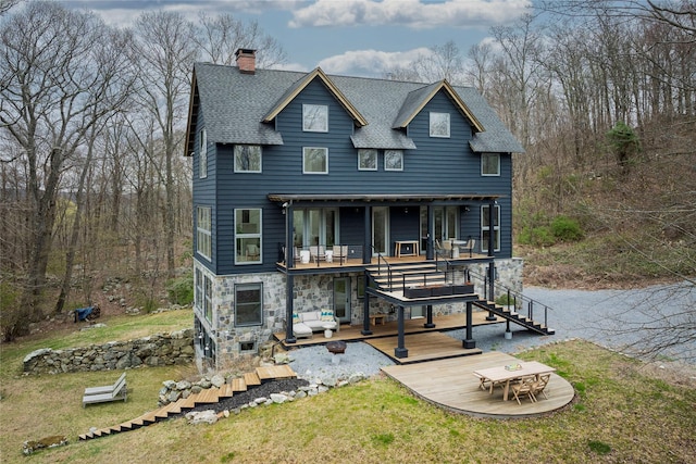 21 Private Way, Garrison, NY 10524 - view of front of home with a shingled roof, stone siding, stairway, a chimney, and a patio area