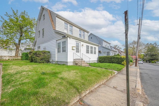 dutch colonial with entry steps and a front yard