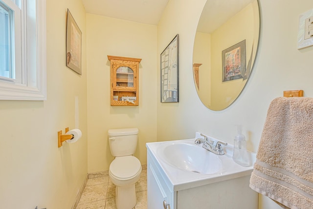 bathroom with tile patterned floors, vanity, toilet, and baseboards