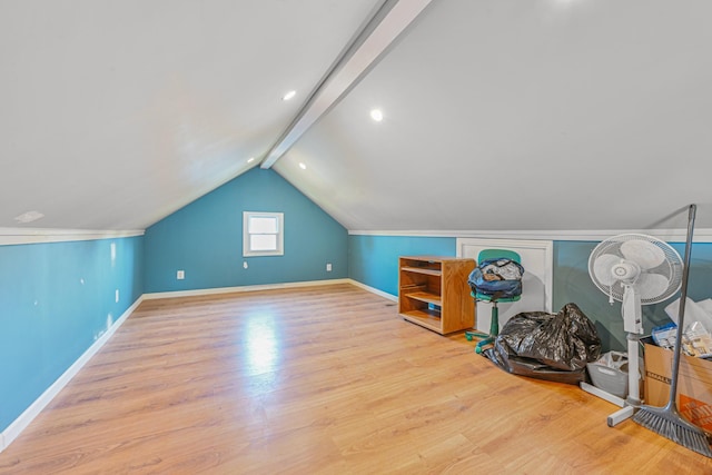 additional living space featuring wood finished floors, vaulted ceiling, and baseboards