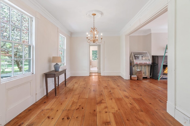 64 Paulding Ave, Cold Spring, NY 10516 - unfurnished dining area with crown molding, an inviting chandelier, and light wood-style floors