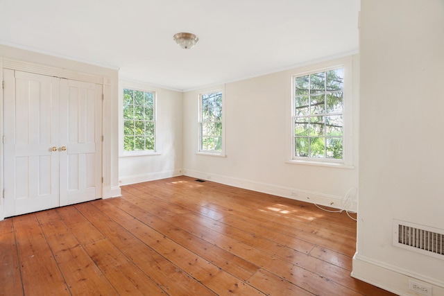 64 Paulding Ave, Cold Spring, NY 10516 - unfurnished bedroom featuring baseboards, multiple windows, light wood finished floors, and visible vents