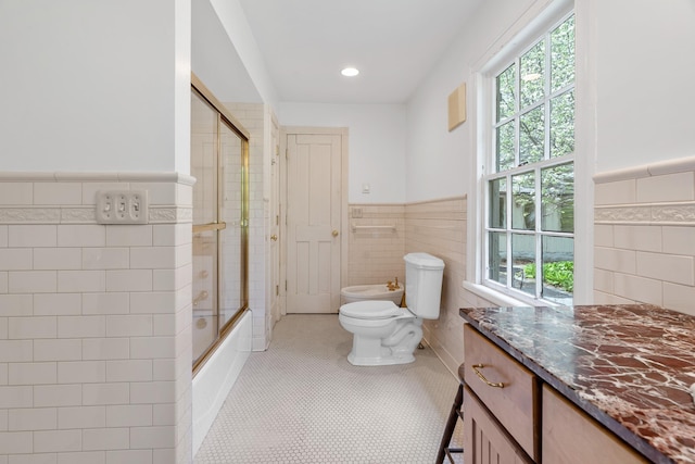 64 Paulding Ave, Cold Spring, NY 10516 - bathroom featuring tile walls, a wainscoted wall, and a bidet