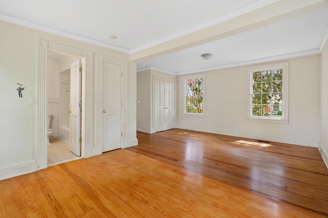 64 Paulding Ave, Cold Spring, NY 10516 - unfurnished bedroom featuring light wood-style floors, baseboards, ornamental molding, and connected bathroom