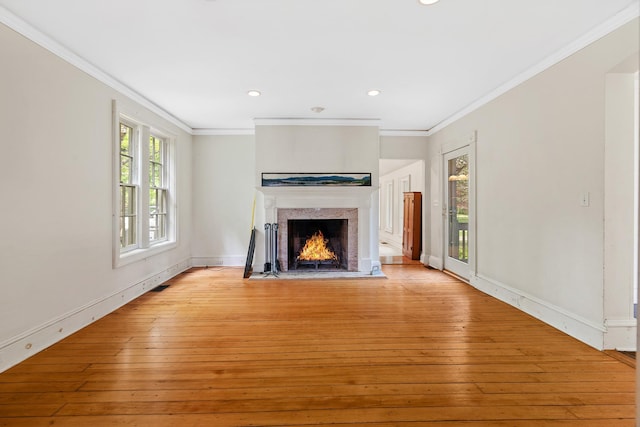 64 Paulding Ave, Cold Spring, NY 10516 - unfurnished living room with crown molding, recessed lighting, light wood finished floors, and a lit fireplace