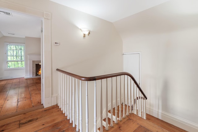 64 Paulding Ave, Cold Spring, NY 10516 - stairway with visible vents, a high end fireplace, vaulted ceiling, and hardwood / wood-style floors