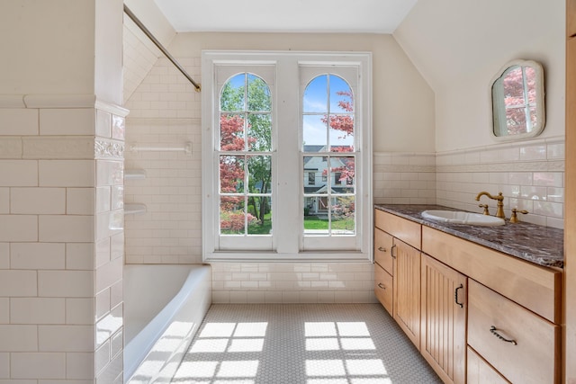 64 Paulding Ave, Cold Spring, NY 10516 - bathroom with tile walls, walk in shower, vanity, lofted ceiling, and a tub to relax in