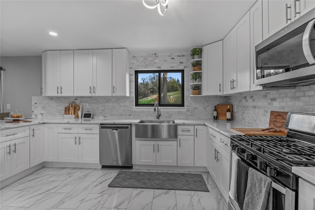 kitchen featuring stainless steel appliances, open shelves, marble finish floor, white cabinets, and a sink