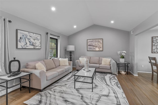 living room featuring lofted ceiling, a baseboard radiator, visible vents, recessed lighting, and wood finished floors