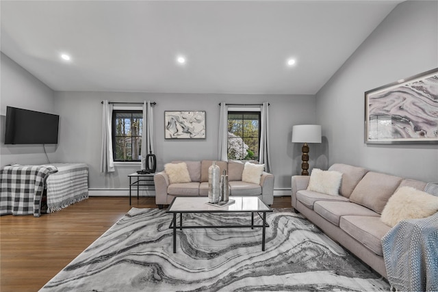 living area featuring recessed lighting, wood finished floors, lofted ceiling, and a baseboard radiator