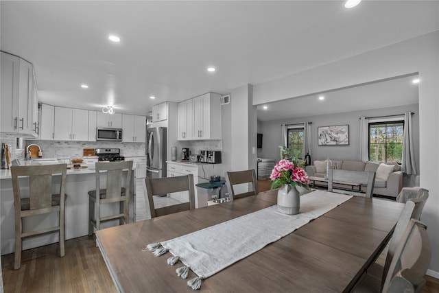 dining room with recessed lighting, visible vents, and wood finished floors