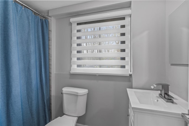 bathroom featuring toilet and vanity