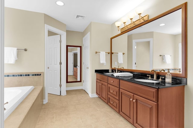 full bath featuring double vanity, a bath, a sink, baseboards, and visible vents