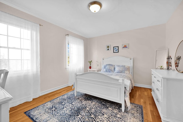 bedroom featuring light wood-type flooring and baseboards