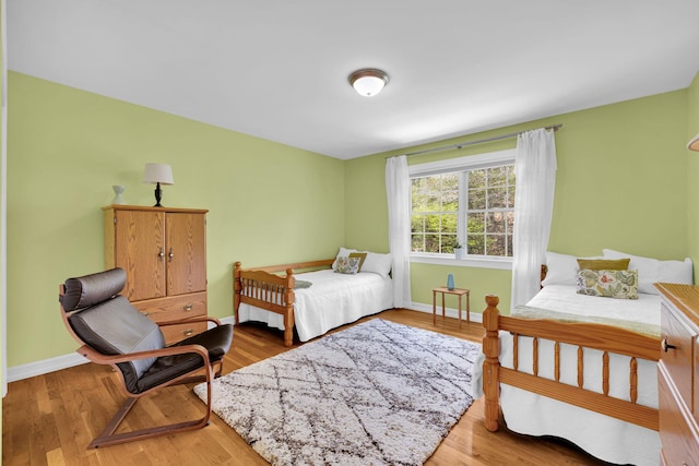 bedroom featuring baseboards and light wood-type flooring