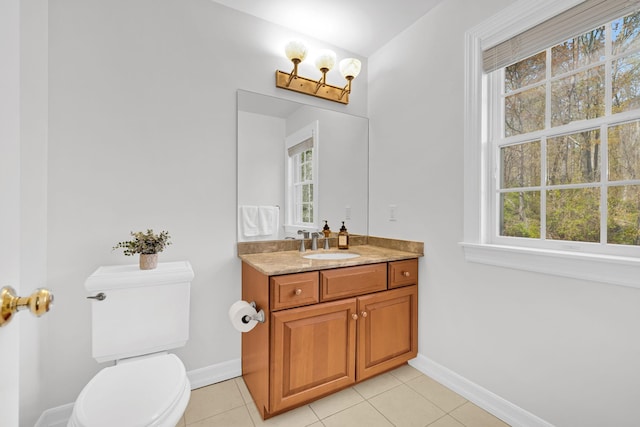 bathroom featuring a healthy amount of sunlight and baseboards