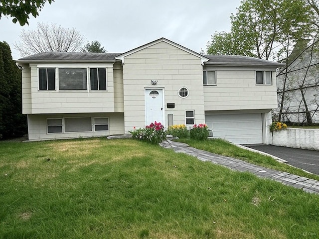 5 Elm St, Great Neck, NY 11021 - bi-level home with roof with shingles, an attached garage, driveway, and a front yard