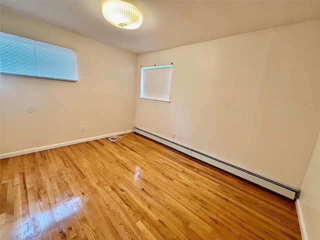 5 Elm St, Great Neck, NY 11021 - spare room featuring baseboards, a baseboard radiator, and wood finished floors