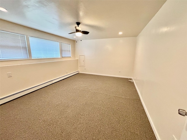 5 Elm St, Great Neck, NY 11021 - unfurnished room with baseboards, a ceiling fan, baseboard heating, and dark colored carpet