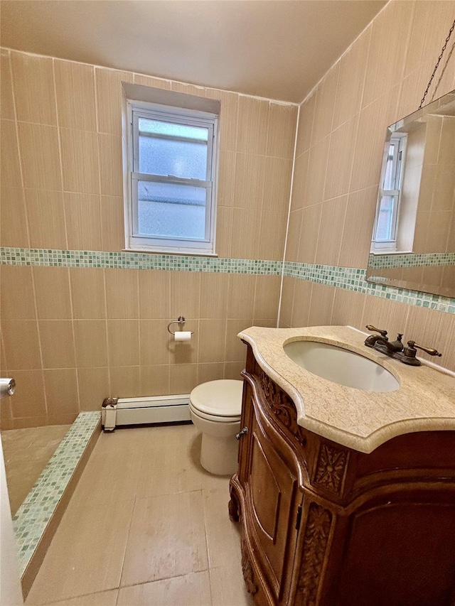 5 Elm St, Great Neck, NY 11021 - full bath with tile walls, a tile shower, vanity, a baseboard radiator, and toilet