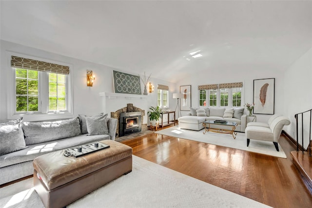 10 Maple Hill Dr, Larchmont, NY 10538 - living room with wood finished floors, plenty of natural light, vaulted ceiling, a fireplace with flush hearth, and baseboards