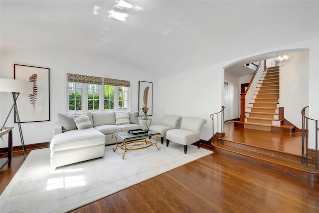 10 Maple Hill Dr, Larchmont, NY 10538 - living area featuring wood finished floors, arched walkways, lofted ceiling, stairway, and baseboards