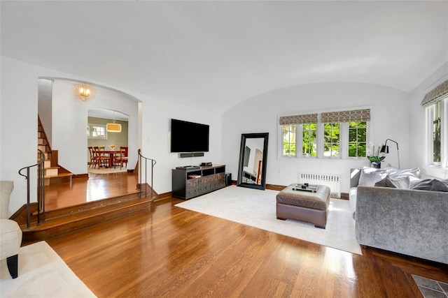 10 Maple Hill Dr, Larchmont, NY 10538 - living room featuring radiator, wood finished floors, healthy amount of natural light, vaulted ceiling, and baseboards