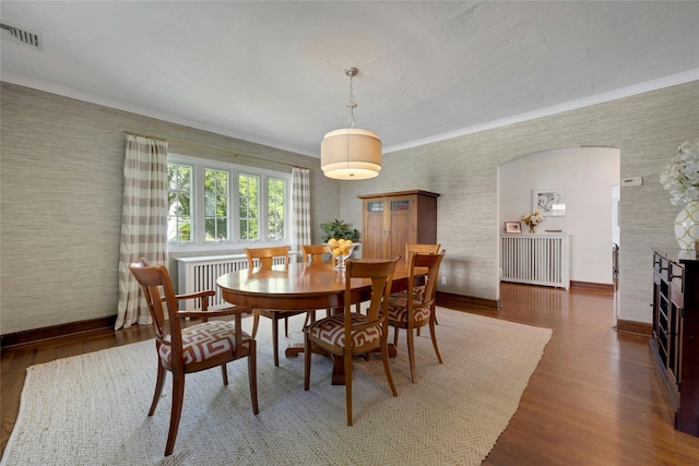 10 Maple Hill Dr, Larchmont, NY 10538 - dining area featuring wood finished floors, baseboards, ornamental molding, radiator heating unit, and wallpapered walls