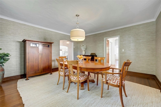 10 Maple Hill Dr, Larchmont, NY 10538 - dining room with light wood-style flooring, baseboards, arched walkways, ornamental molding, and wallpapered walls