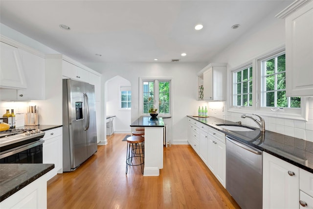 10 Maple Hill Dr, Larchmont, NY 10538 - kitchen with stainless steel appliances, a sink, plenty of natural light, a kitchen bar, and recessed lighting