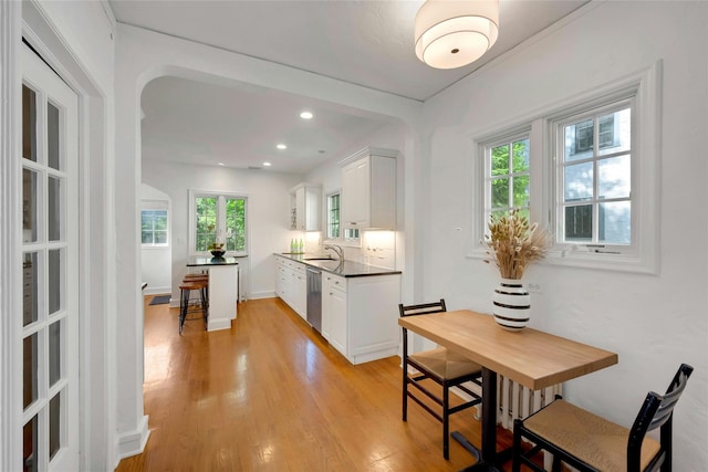 10 Maple Hill Dr, Larchmont, NY 10538 - kitchen featuring a sink, dark countertops, white cabinetry, light wood-type flooring, and recessed lighting