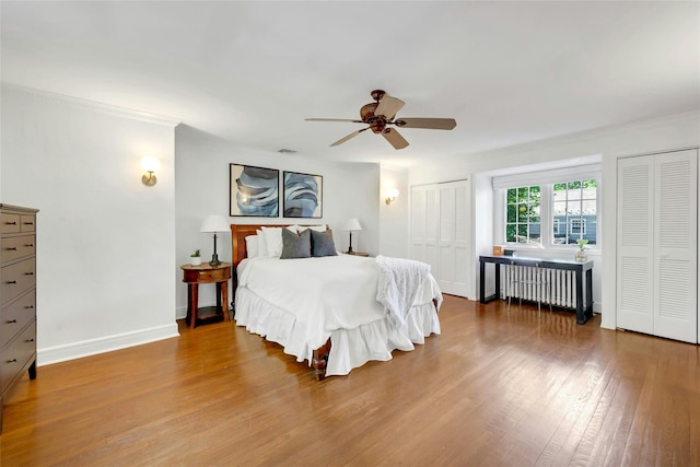 10 Maple Hill Dr, Larchmont, NY 10538 - bedroom with radiator, multiple closets, wood finished floors, baseboards, and ornamental molding