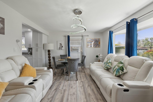 living area featuring light wood-type flooring and baseboards