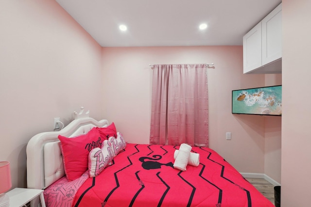 bedroom featuring baseboards, recessed lighting, and wood finished floors